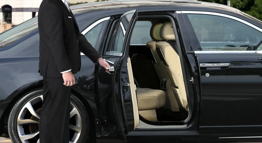 Chauffeur holding a luxury car door open.